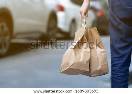 A woman order some food take home for eating in house during self quarantined, COVID-19 crisis  Royalty-Free Stock Photo #1689803695