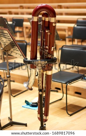 Bassoon in a large concert hall. Woodwind instrument. Red bassoon. Great bassoon. Musical instrument. Royalty-Free Stock Photo #1689817096