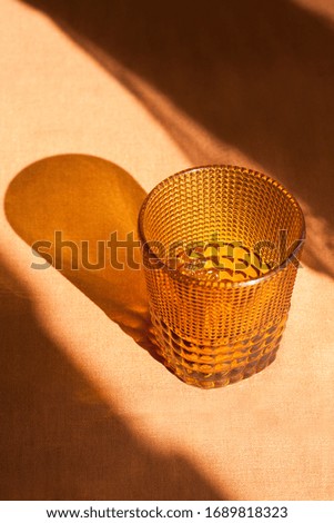 Red water glass with its shadow