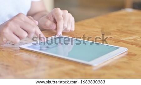 Close Up of Hands Typing on Tablet