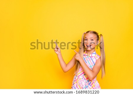 Cheap shopping! Photo of funny cheerful little lady good mood pretty long tails direct finger empty space wear checkered summer dress isolated yellow bright color background