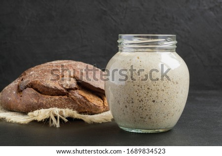 Active rye sourdough in a glass jar for homemade bread.

