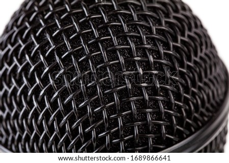 Metal black microphone grill macro, extreme closeup, reflective surface simple background texture, backdrop. Recording vocals, vocal training abstract concept, modern musical equipment up close