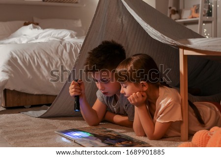 Little children reading bedtime story at home Royalty-Free Stock Photo #1689901885