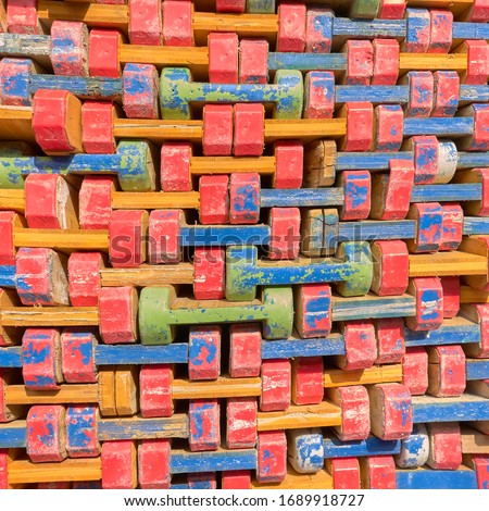 Abstract view of colorful wooden timber formwork beams for building constructions, stacked on a pile.