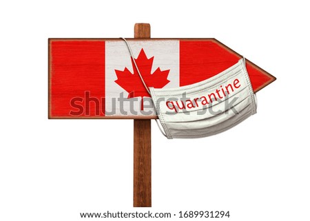 Quarantine during the COVID-19 coronavirus pandemic in Canada. Medical mask with the inscription QUARANTINE hangs on a sign pointer with the image of the flag of Canada. Anti-epidemic measures.
