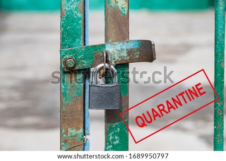 The entrance is locked. The prevention of the epidemic quarantine. Coronavirus disease, warning sign. Biohazard, not transport. The lock is hanging on the fence.