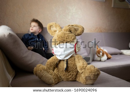 boy sits with a toy in a medical bandage