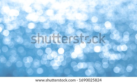 Abstract light blue background with white bokeh
