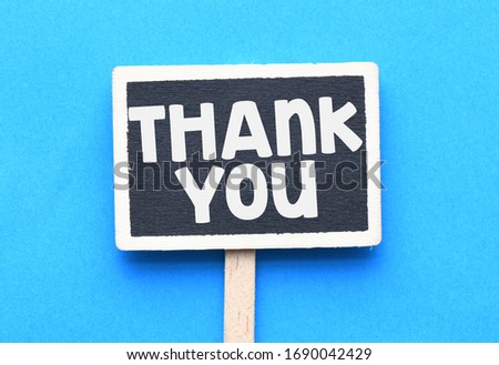 THANK YOU. Mini chalkboard with the word thank you on blue background.
