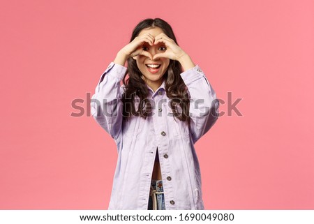 Found my true love, soulmate. Lively charismatic beautiful korean girl spot something lovely, look at camera from heart sign and smiling happy, being romantic and silly, pink background