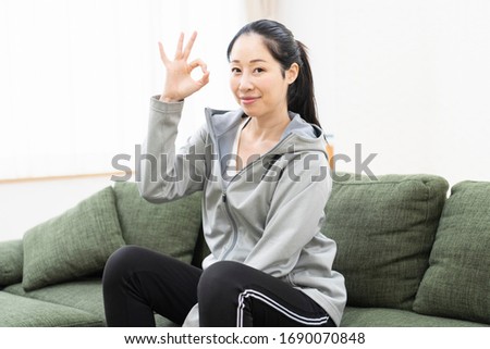 Young woman making OK sign shot in studio