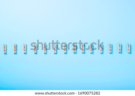 clothespins on a blue background copy space. washing concept