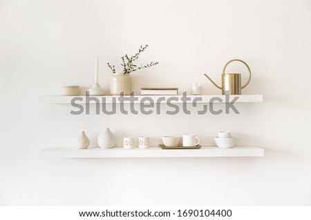 Minimalistic. Cozy light home style. Scandinavian interior. Dishes on white shelves. White details in the interior.  Royalty-Free Stock Photo #1690104400