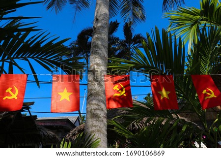 Vietnamese red with yellow star Flag and Communist Party of Vietnam flag in the Wind. Waving colorful national Vietnamese flag