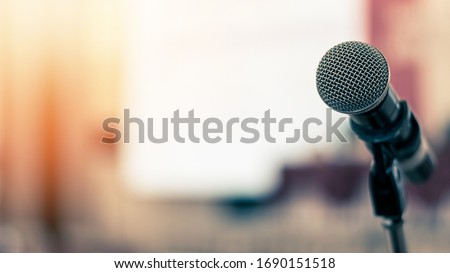 Microphone voice speaker in business seminar, speech presentation, town hall meeting, lecture hall or conference room in corporate or community event for host or townhall public hearing Royalty-Free Stock Photo #1690151518
