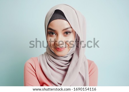 Portrait of Asian cute smile Muslim teenage girl wearing islamic dress hijab is looking to camera. Royalty-Free Stock Photo #1690154116
