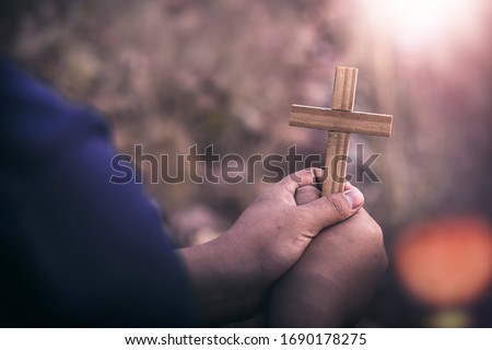 Close up crucifix in hands of human, Christian concept background.