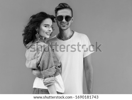 Young fashion couple on background. Black and white photography