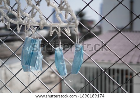 BANGKOK, THAILAND - March 30,2020 : used mask to kill germs with sunlight for reuse to prevent the corona virus Royalty-Free Stock Photo #1690189174
