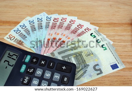 Money euro and calculator on the table