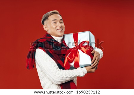 Asian man with a gift box in his hands, Christmas and New Year 2021