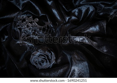 Black metal mask from Venice with black rose on black velvet