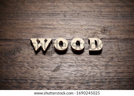 Wood word on a wood table.