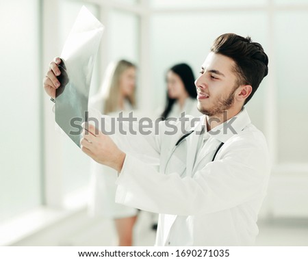 successful pediatrician standing in the hallway of the medical