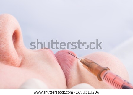 side view of a doctor giving an injection to enlarge a girl’s lips