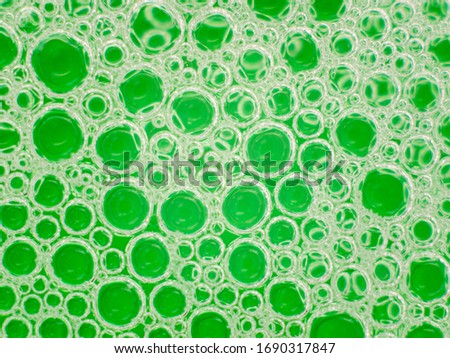 Neon green liquid pumps. Abstract background