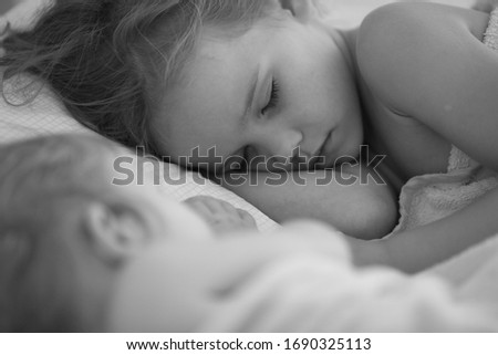 little girl sleep in bed at home. the mode of the day. black-white