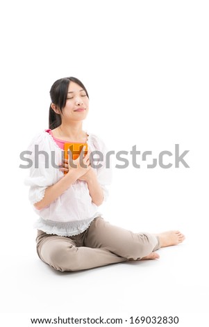 attractive asian woman reading book on white background