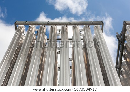 Compressed natural gas decompression gasifier. CNG industrial pipes tower with blue sky Royalty-Free Stock Photo #1690334917