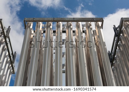 Compressed natural gas decompression gasifier. CNG industrial pipes tower with blue sky Royalty-Free Stock Photo #1690341574