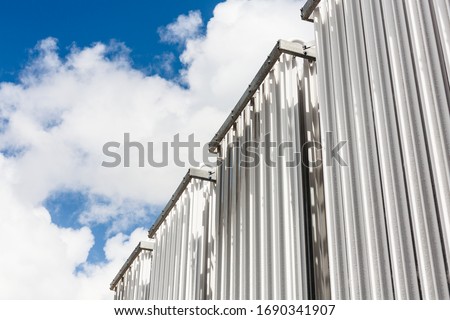 Compressed natural gas decompression gasifier. CNG industrial pipes tower with blue sky Royalty-Free Stock Photo #1690341907