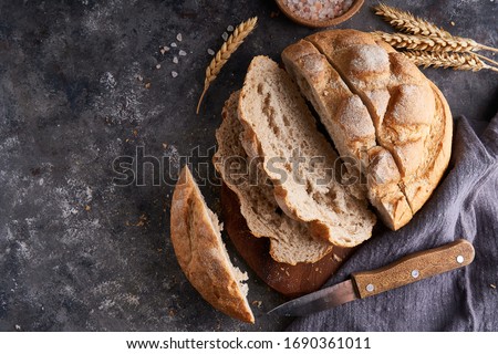 Homemade gluten free bread on a napkin on the kitchen table Royalty-Free Stock Photo #1690361011