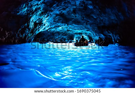 Dark inside of the Grotta Azzurra in Capri Island, Italy, for background Royalty-Free Stock Photo #1690375045