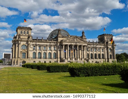Reichstag building, where the German parliament is (Bundestag) with a blue and cloudy sky in Mitte district, Berlin, Germany Royalty-Free Stock Photo #1690377112