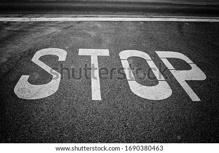 Stop sign painted on the road, traffic ban