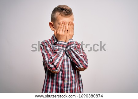 Young little caucasian kid with blue eyes wearing elegant shirt standing over isolated background rubbing eyes for fatigue and headache, sleepy and tired expression. Vision problem
