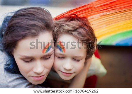 let's all be well. child and mother at home draws a rainbow on window. Flash mob society community on self-isolation quarantine pandemic coronavirus. Children Chase the rainbow