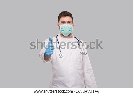 Male Doctor Showing Thumb Up Wearing Medical Mask and Gloves. Royalty-Free Stock Photo #1690490146