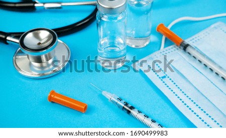 Stethoscope and Face Mask on Blue Background. Concept of health care, nurse or doctor, clinic or hospital
