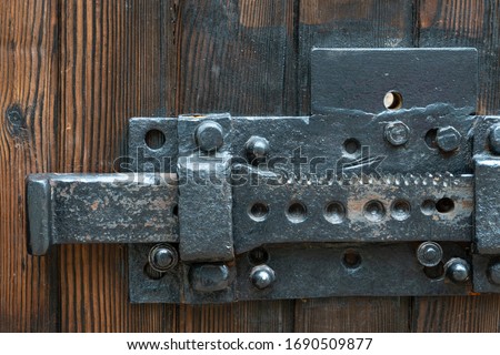 Old wooden doors. A big old iron lock. An ancient mechanism for locking doors.