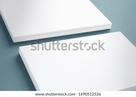 2 blank business cards stack on textured grey background close-up view as template for design, logo, embossing presentation, promotion, branding etc.