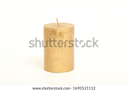 golden candle on a white background