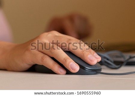 Person working from home with a mouse and computer