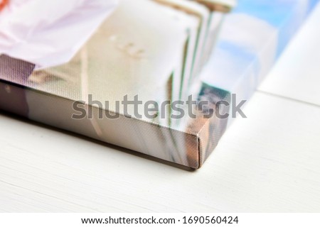 Photo printed on synthetic canvas, corner of photography with gallery wrapping method of canvas stretching on stretcher bar, lateral side, selective focus