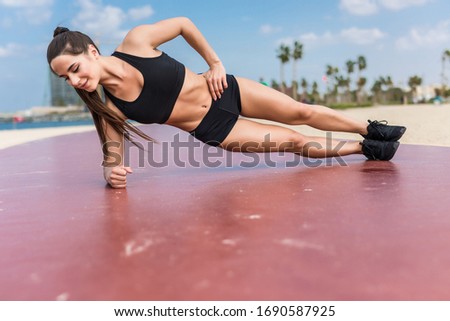 Fitness woman strength training her body core muscles with yoga pose. Royalty-Free Stock Photo #1690587925
